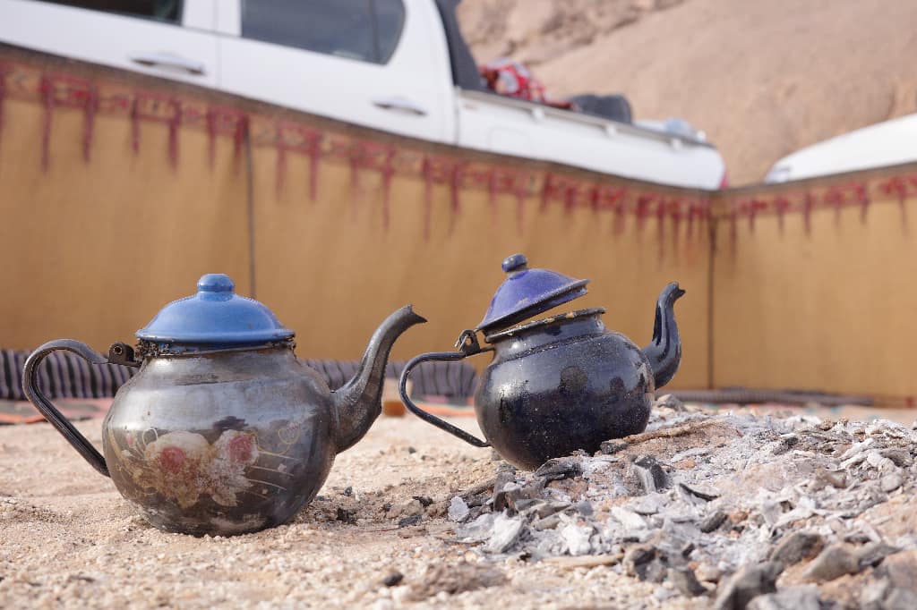 Teapots, coals, camp.